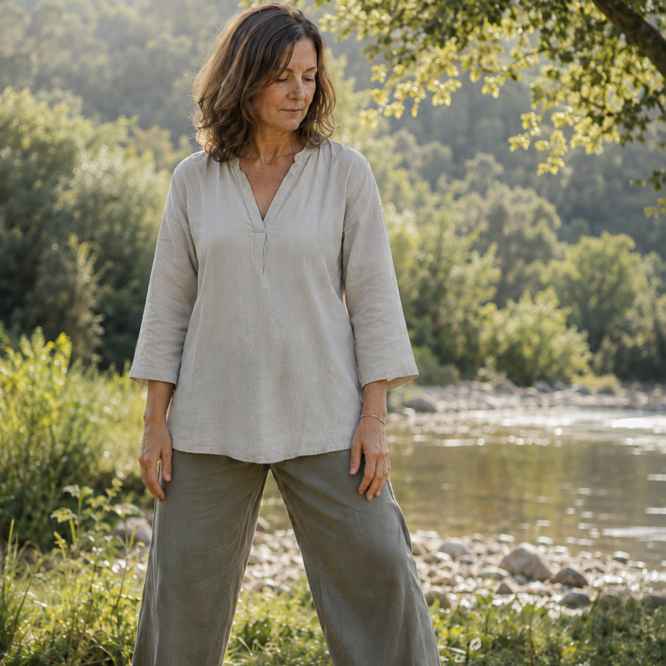 Woman standing quietly in nature beside a river